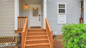 A wooden staircase leading to a white door with a number plate, a small window, and a mailbox. - Lakefront Beautiful Townhome w/ Stunning Views! (North Charleston)
