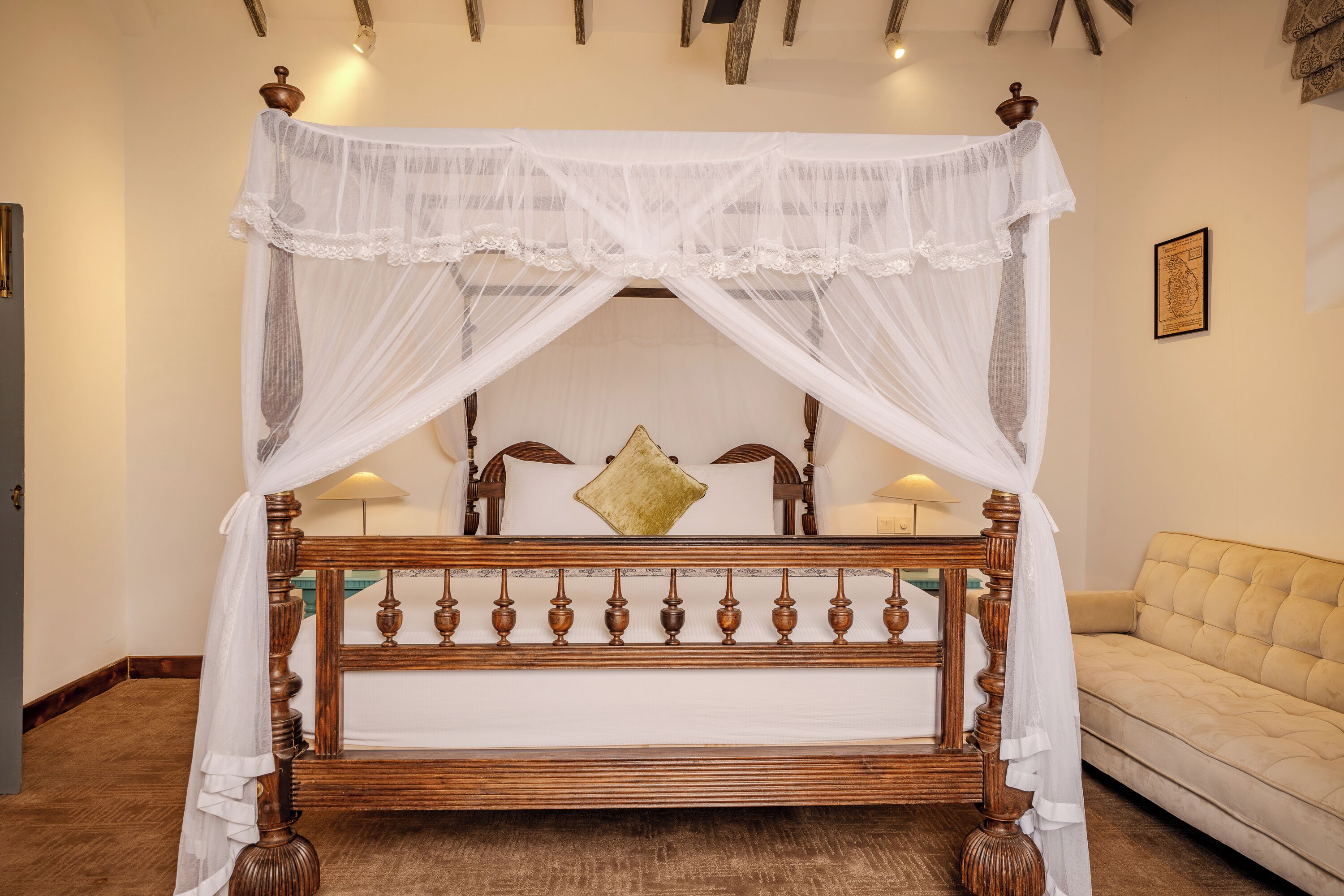 A four-poster bed with a canopy, wooden headboard, and a gold pillow.