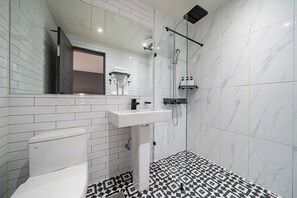 A modern bathroom with a white toilet, a sink, and a shower area. - SEONGNAM HEALASIS HOTEL MORAN STATION (Seongnam)