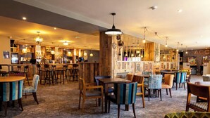 A restaurant with wooden decor, multiple seating areas, and a bar. - Rc 39 (Felixstowe)