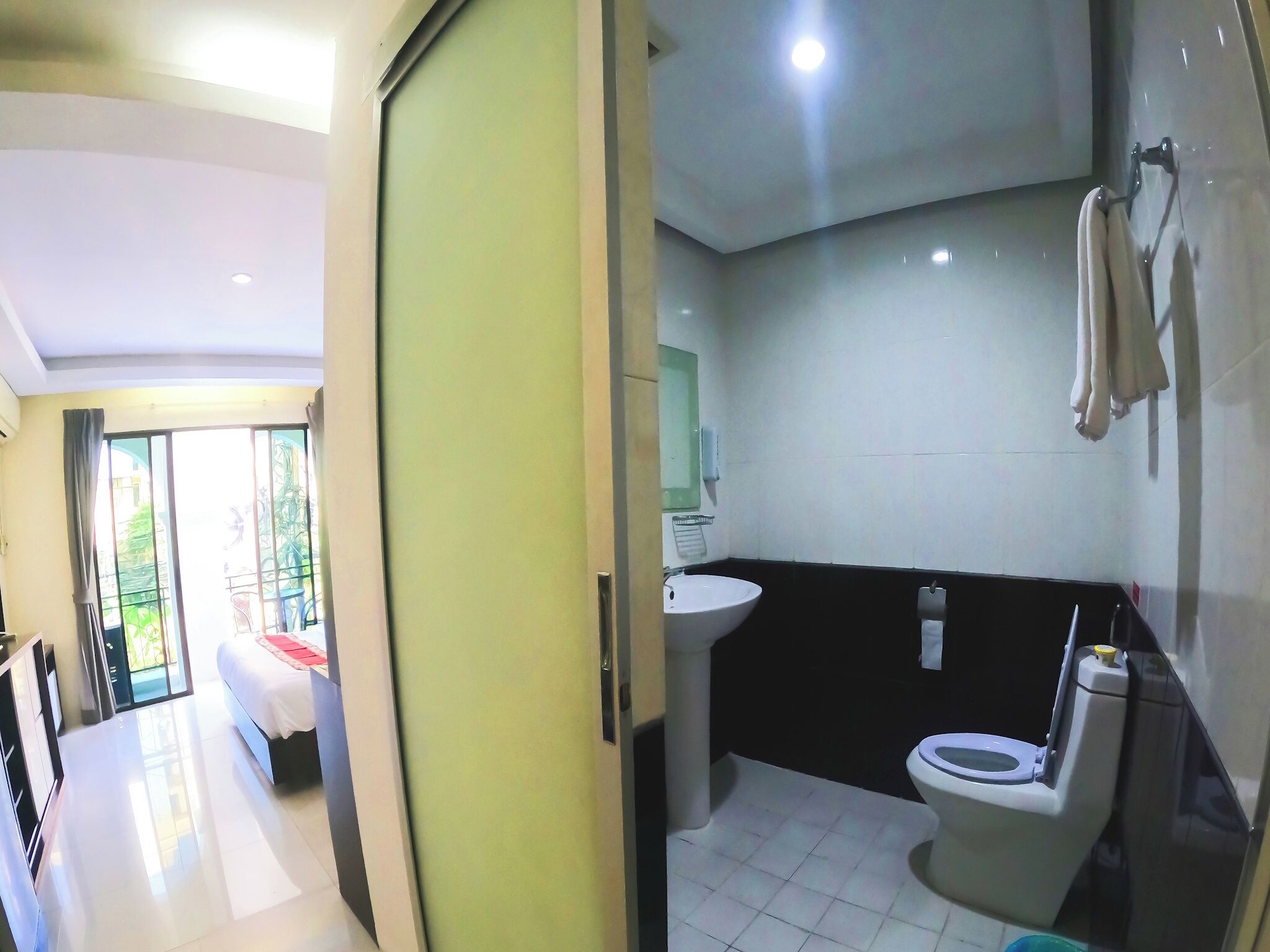 A modern bathroom with a toilet, sink, and a mirror.