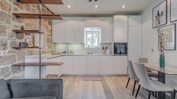 Deluxe Apartment | Living area | 100-cm flat-screen TV with cable channels, Netflix, streaming services