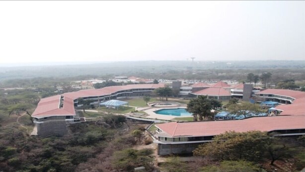 Ein Resort mit Pool, mehreren Gebäuden und einer umliegenden Landschaft.
