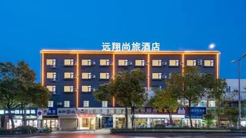 A multi-story hotel with a prominent sign at the top.