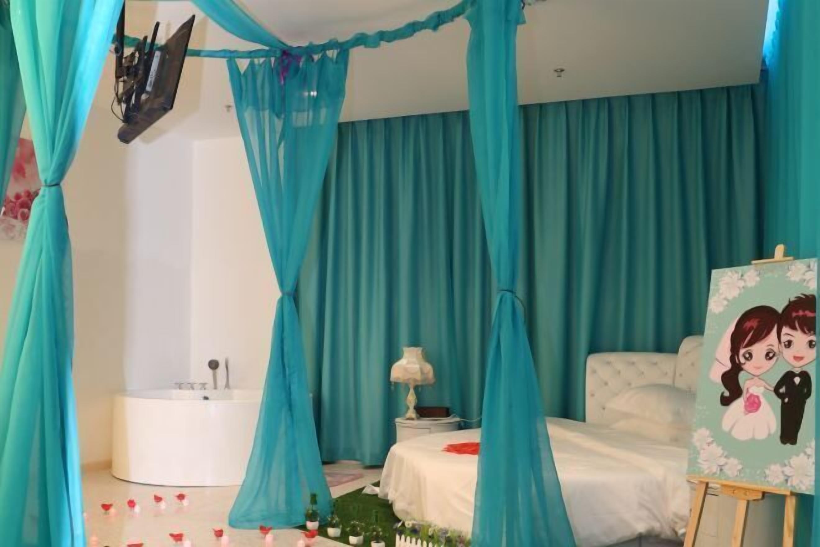 A bedroom with a canopy bed, a painting on the wall, and a bathtub in the corner.