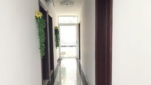 A hallway with a polished floor, a door on the right, and a window at the end. - Ningguo Annan Sichuan-Tibet Line Fengbanzhan (Ningguo)