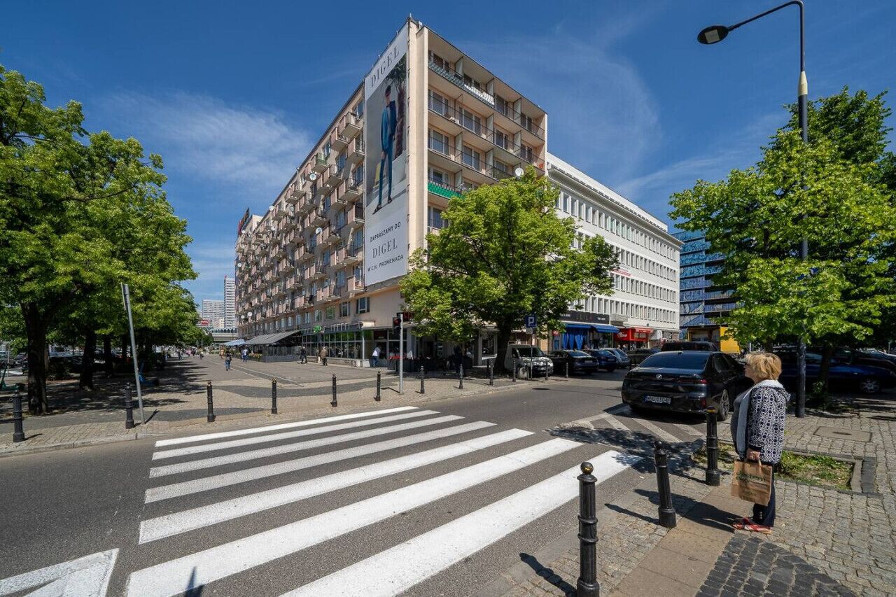 A multi-story building with a prominent advertisement on the side.