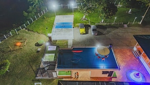 An aerial view of a residential property with a swimming pool, a covered patio, and a fenced yard. - Raizes AXM (Circasia)