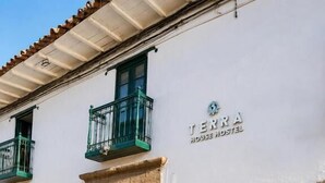 A building with a sign reading 'TERRA HOUSE HOSTEL' and a stone facade. - Terra House (Cusco)