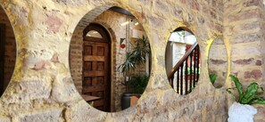 A rustic interior with a wooden door, a staircase, and a potted plant. - QUINTA SEIS TRES (Bogotá)