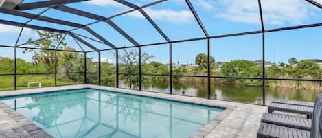An indoor swimming pool with a clear view of the surrounding landscape.