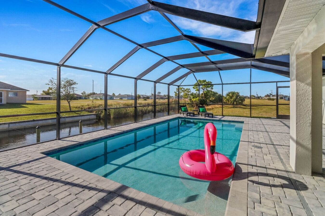 A covered outdoor swimming pool with a clear view of the surrounding landscape.