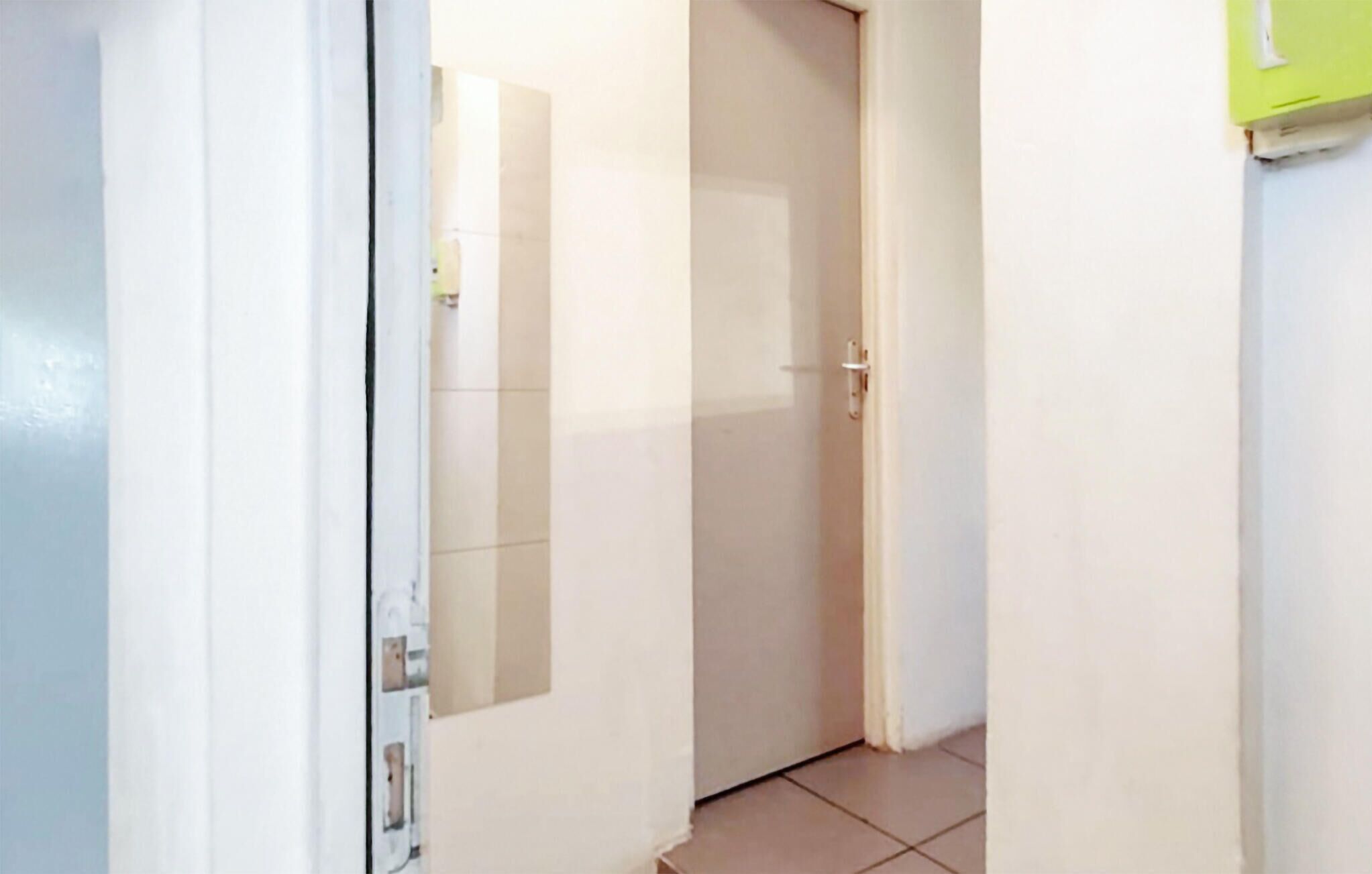 A narrow hallway with a closed door at the end.