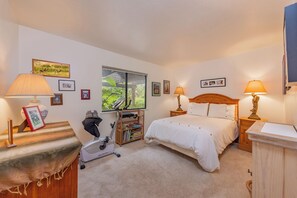 A bedroom with a bed, two bedside lamps, a treadmill, a window with a view of greenery, and several framed pictures on the walls. - Ojai Home in downtown
NEW LISTING DISCOUNT!
2 bedrooms - sleeps 4
- 2bathrooms (Ojai)
