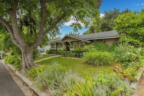 A single-story house with a front yard, surrounded by lush greenery and flowering plants. - Ojai Home in downtown
NEW LISTING DISCOUNT!
2 bedrooms - sleeps 4
- 2bathrooms (Ojai)