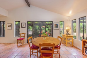 A dining area with a round wooden table, four wooden chairs with red cushions, a small wooden side table with a lamp, and a bookshelf. - Ojai Home in downtown
NEW LISTING DISCOUNT!
2 bedrooms - sleeps 4
- 2bathrooms (Ojai)