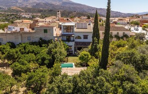 Escape to a serene Mediterranean villa surrounded by lush greenery and mature trees.