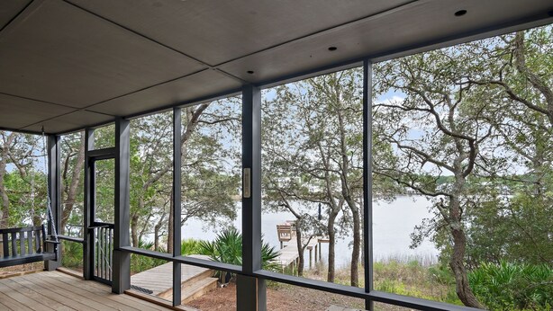 A covered outdoor deck with a view of a lake and trees. - Waterfront/Walk to Public Beach! (Seagrove Beach)