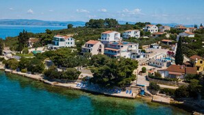 A coastal village with houses, a beach, and a clear view of the sea. - Boutique Guesthouse Sveti Petar (Solta)