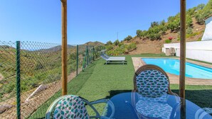 A poolside area with a view of a mountainous landscape, a covered seating area, and a fenced garden. - Lovely home in Canillas de Albaidas (Canillas de Albaidas)