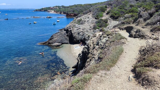 A coastal landscape with clear blue water, rocky terrain, and sparse vegetation. - Cabano for rent by the sea  (Hyères)