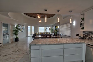 Enjoy cooking and dining in this well-equipped kitchen with a central island and sleek cabinetry.