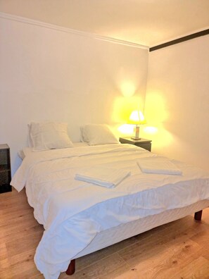 Restful retreat with a neatly made bed and bedside table.