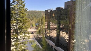 A modern building with a glass facade reflecting trees and a clear sky. - Everline Resort & Spa: Deluxe Two-Bedroom Penthouse
Ski In/Out, Golf, Spa, Pool (Olympic Valley)