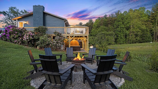 A house with a deck, a fire pit, and outdoor seating. - Sauna & Hot Tub Chalet w/ Game Room, 6BR (Asheville)