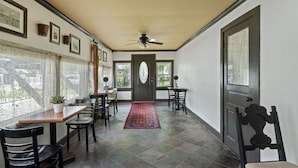A hallway with a dining area, a ceiling fan, and a door with a window. - Discover the charm of Colonial Beach (Colonial Beach)