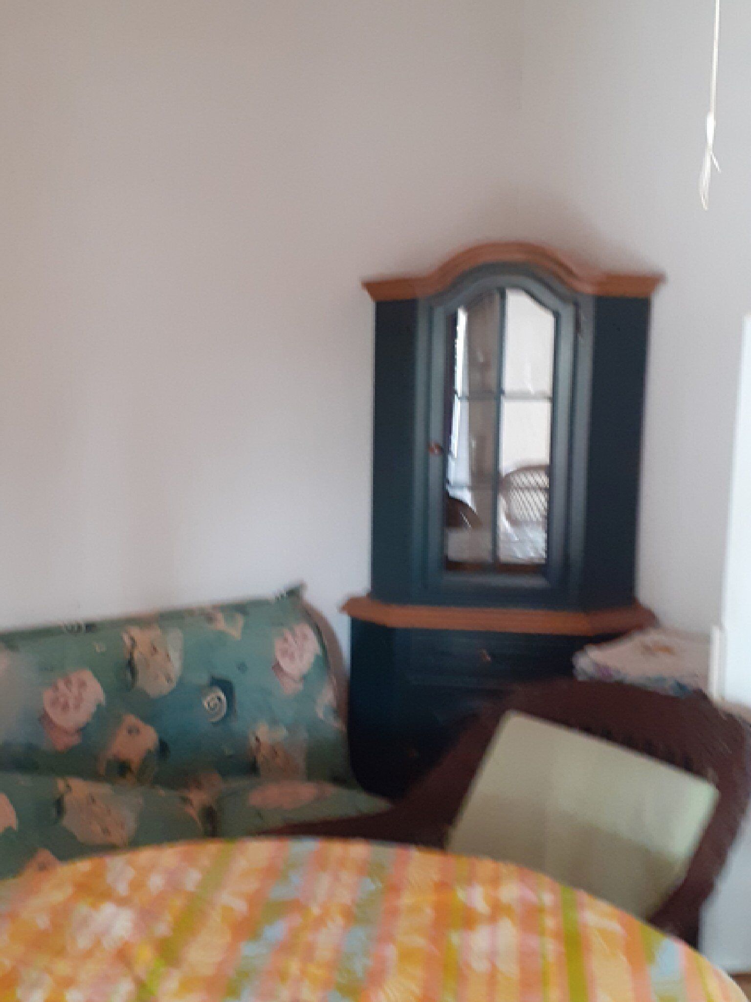 A bedroom with a bed, a dresser, and a mirror.
