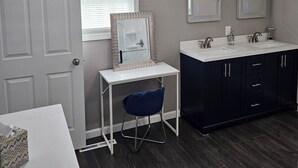 A bathroom with a white vanity, two sinks, a mirror, and a door. - Modern 3BD/2BA near U of I with a large master suite! (Champaign)