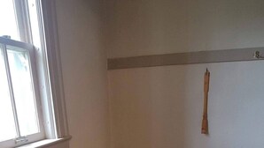 A room with a wooden floor, a window, and a door. - Our cozy apartment is your home away from home. 
 (Hibbing)