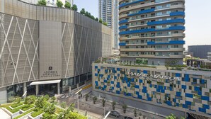 A modern hotel with a distinctive facade, featuring a mix of geometric patterns and balconies. - Apartment in Downtown Dubai Near Burj Khalifa (Dubai)