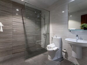 A modern bathroom with a glass shower enclosure, a toilet, and a sink. - Chalet in Austria Near Ski Slope (Dubai)