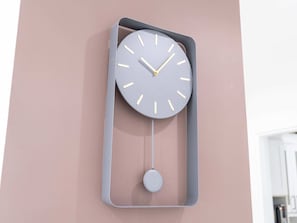 A wall-mounted clock with a minimalist design, featuring a grey frame and a simple, round face with white hour markers. - Luxe 4bed Apt Dubai Marina JBR Pool by Belvilla (Dubai)