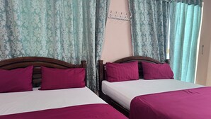 Two beds with wooden headboards, each with a white mattress and a purple bedspread. - OYO 90981 Chenang Rest House 1 (Langkawi)