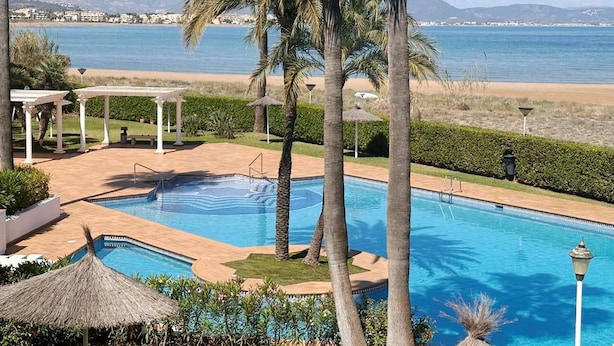A pool with a view of the beach and mountains in the background. - Beautiful and comfortable apartment  with communal pool in Denia, Costa Blanca, Spain for 4 persons (Denia)