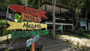 A wooden signpost with directional arrows pointing to various locations such as Rustic, Hornhill, Marsh, Beach View, and Free Zone. - OYO 90980 Rainbow Island Sepanggar (Sepanggar Island)