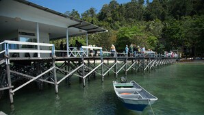 A pier with a dive center and people on it. - OYO 90980 Rainbow Island Sepanggar (Sepanggar Island)