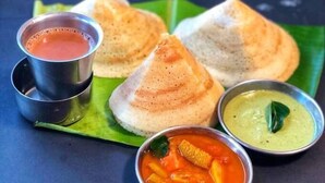 A meal consisting of idlis, coconut chutney, sambar, and a tomato-based dish, served on a banana leaf. - The Green Cube (Kodaikanal)