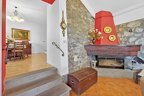 A staircase leading to a dining area with a stone wall and a fireplace. - Casa Sant'anna With Pool - in Garfagnana (Minucciano)