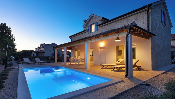 A modern house with a swimming pool, outdoor seating, and a covered patio area. - Papa's court Mediterranean Pasman Villa with pool II (Pasman)