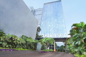 A modern building with a glass facade and a sign that reads "somerset."