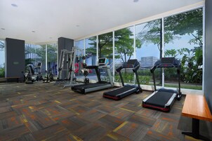 A gym with treadmills, elliptical machines, and weight equipment.