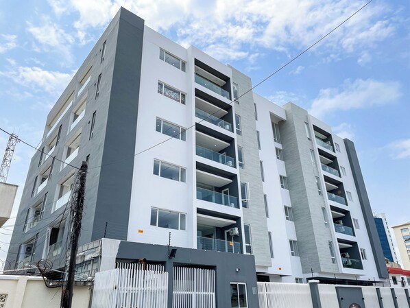 A multi-story building with balconies and large windows. - MiVi (Lagos)