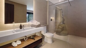 A modern bathroom with a glass-enclosed shower, a white sink, and a wooden vanity. - Villa Jenggala by GORO (Ubud)
