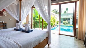 A bedroom with a large bed, a view of a swimming pool, and a balcony with curtains. - Tranquil Escape: Private 4BR Pool Villa with Garden (Rawai)