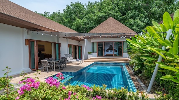 A two-story house with a swimming pool, outdoor seating, and lush greenery. - Tranquil Escape: Private 4BR Pool Villa with Garden (Rawai)