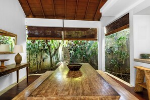 Enjoy meals in the spacious dining area surrounded by lush greenery and natural light.